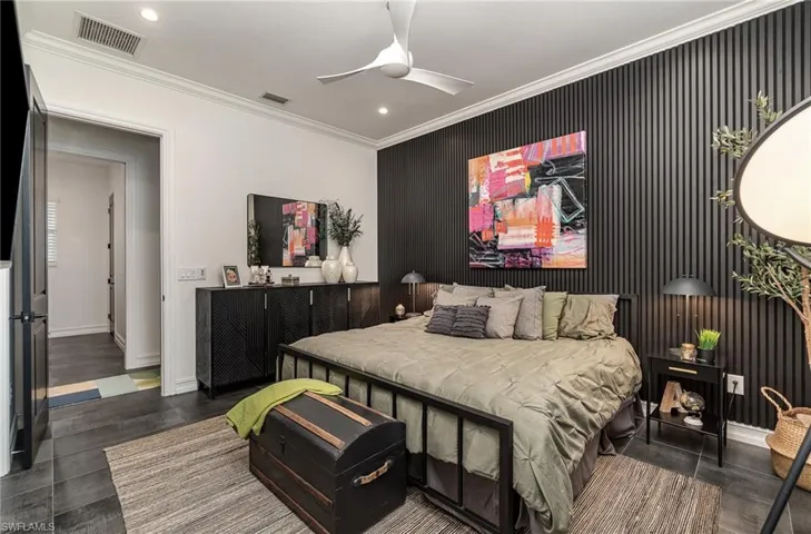 Bedroom featuring crown molding, dark hardwood / wood-style floors, and ceiling fan