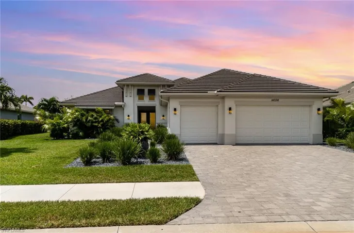 Prairie-style house featuring a garage and a yard
