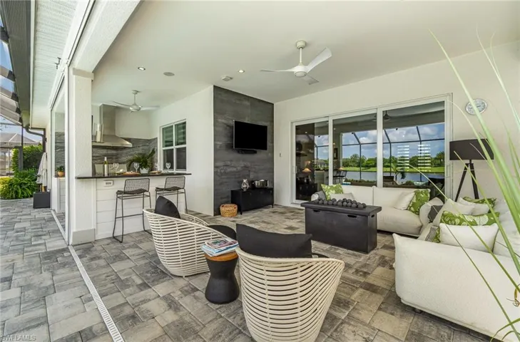 View of patio / terrace featuring ceiling fan, an outdoor bar, and outdoor lounge area