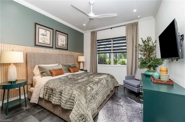 Tiled bedroom with crown molding and ceiling fan
