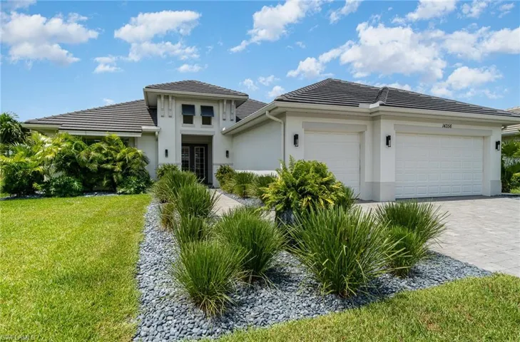 View of front of property with a front yard and a garage