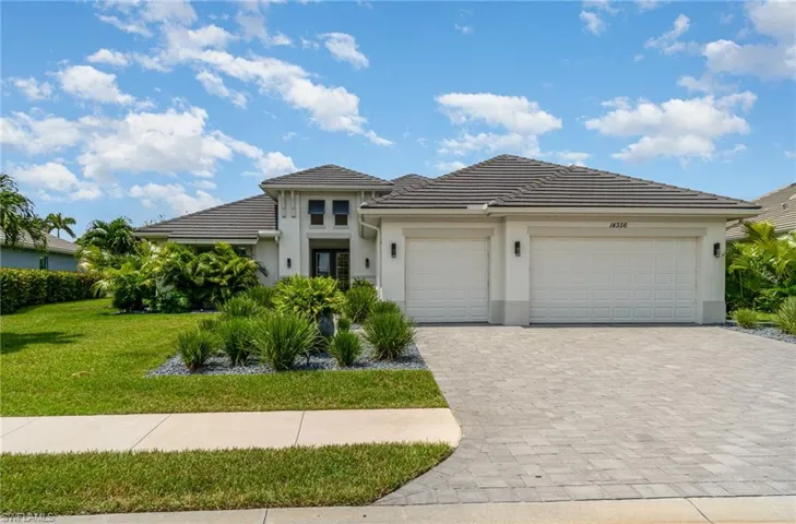 Prairie-style home with a front yard and a garage