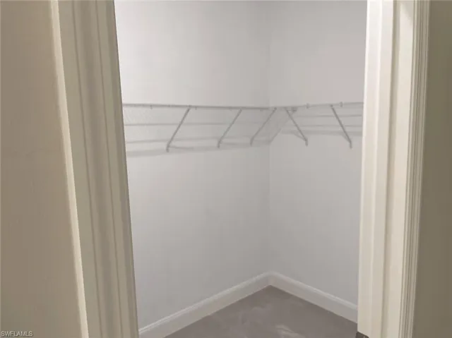 Spacious closet featuring tile floors