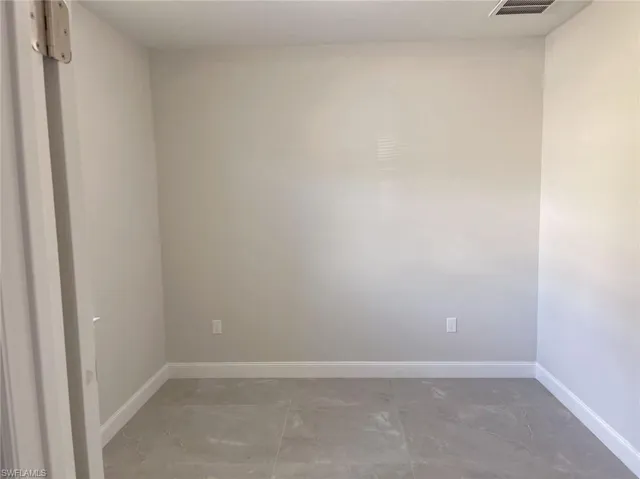 Spare room featuring tile flooring