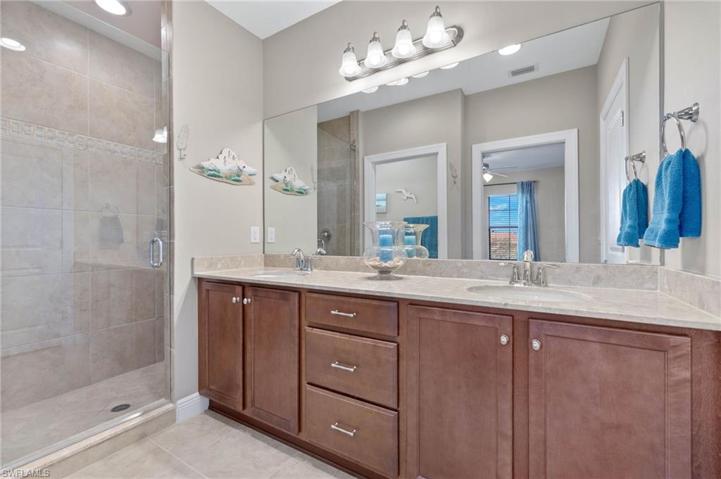 Double sinks and tiled walk in shower