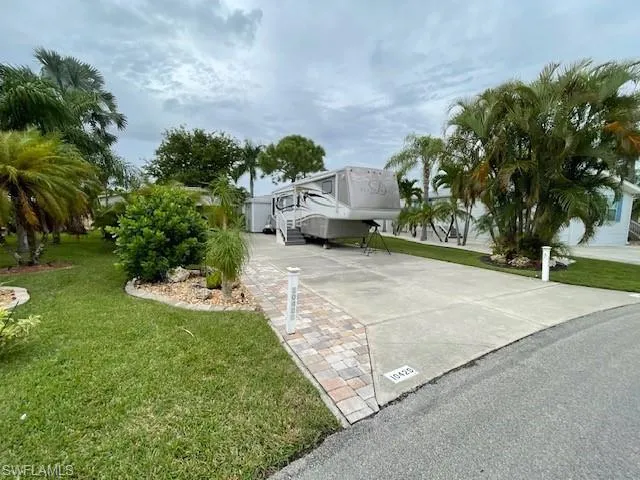 View of property exterior featuring a yard