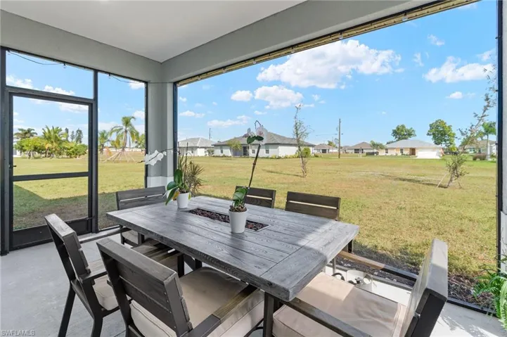Sunroom with a residential view and concrete floors
