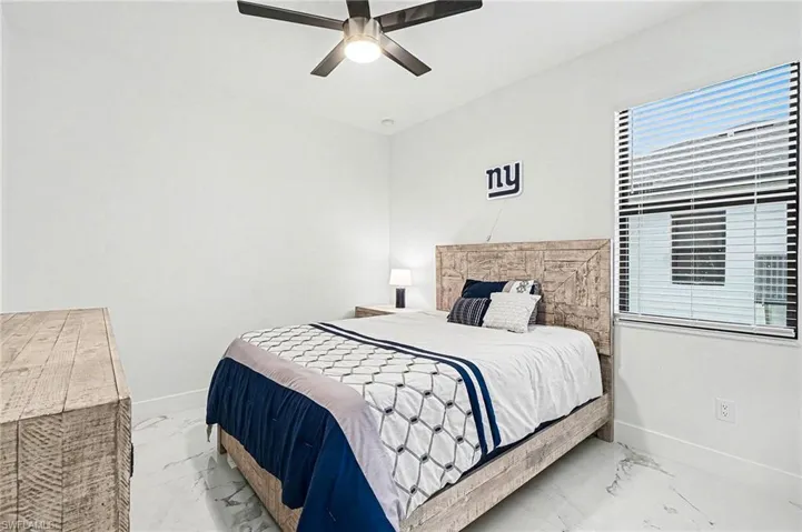Bedroom with baseboards and ceiling fan