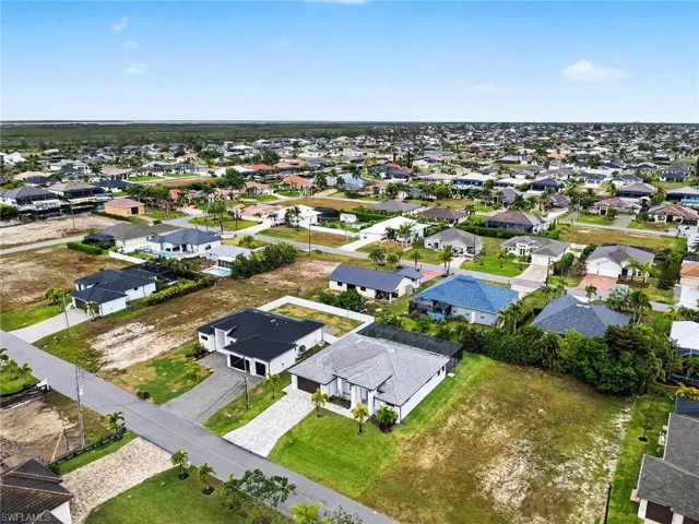Aerial view of property's location featuring nearby suburban area