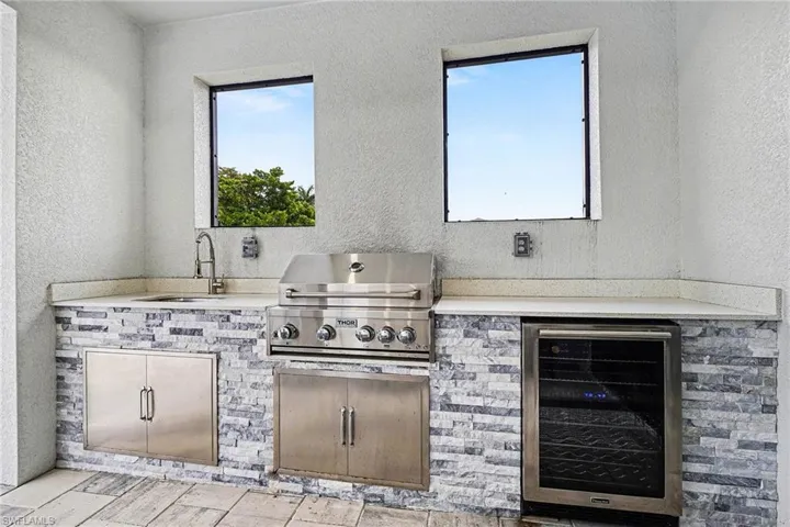 View of patio / terrace with beverage cooler and area for grilling
