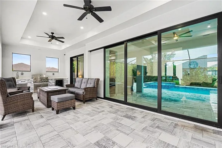 View of patio / terrace featuring an outdoor kitchen and area to lounge, a ceiling fan, and wine cooler