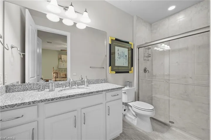 Bathroom featuring a shower stall and vanity