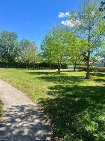 View of property's community featuring a large front lawn