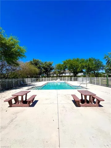 Pool with a patio and fence