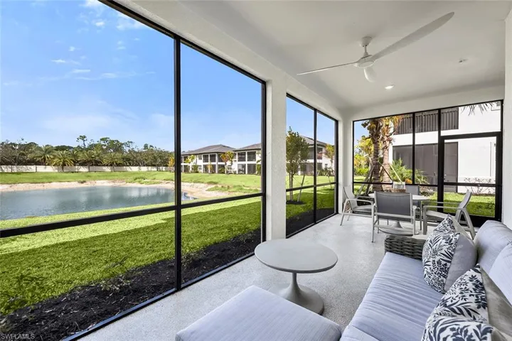 Sunroom featuring a water view and ceiling fan