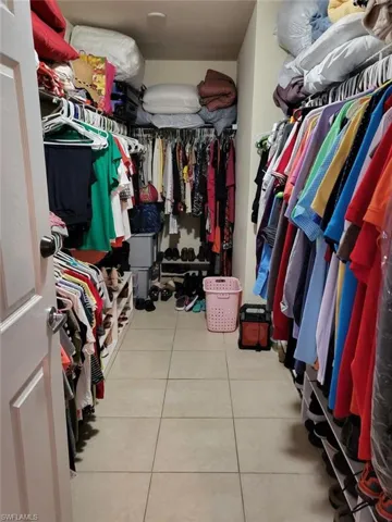 Spacious closet featuring light tile patterned floors