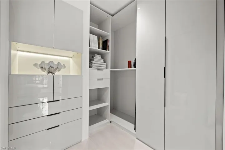 Integrated closet system featuring a high-gloss white finish