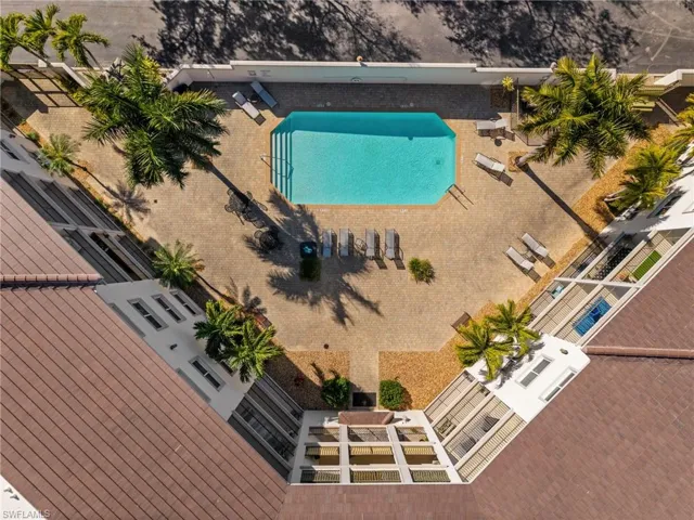 Rectangular swimming pool surrounded by a paver patio