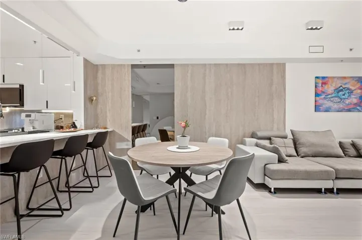 Open-concept living space featuring light wood-finish flooring and recessed lighting
