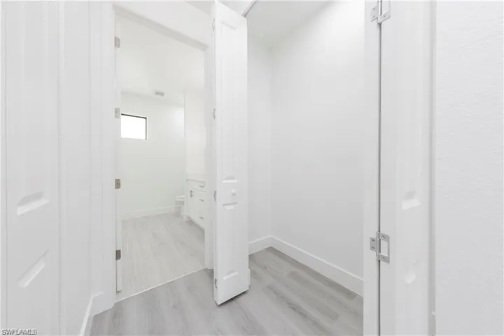Bathroom with light wood-type flooring and baseboards