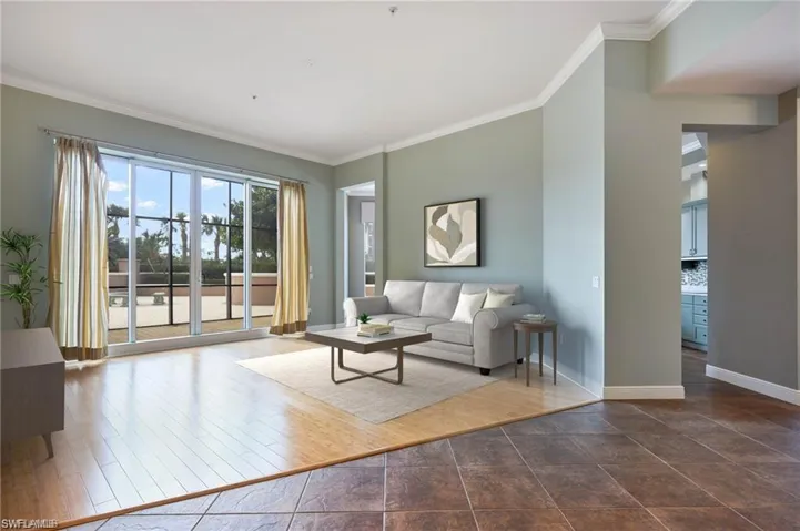 Unfurnished living room with crown molding