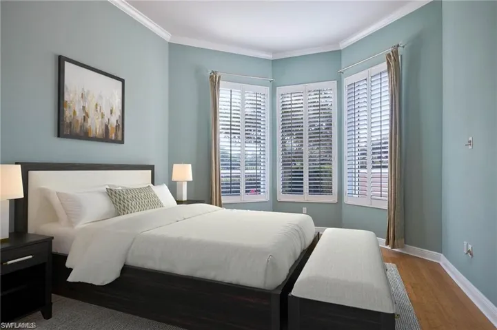 Bedroom featuring hardwood / wood-style flooring and crown molding