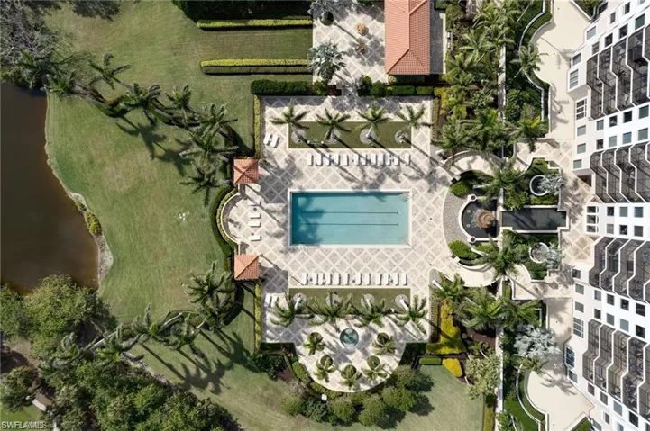 Birds eye view of property with a water view