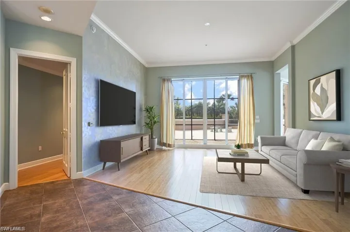 Living room featuring hardwood / wood-style flooring and ornamental molding