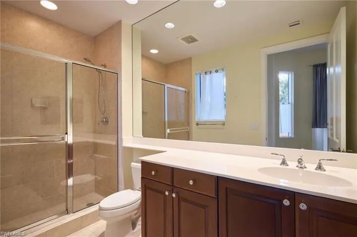 Bathroom with vanity, toilet, and walk in shower