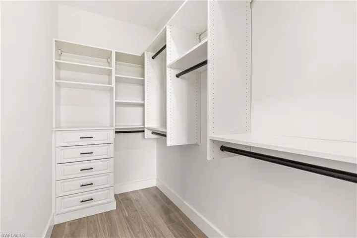 Spacious closet with light wood-type flooring