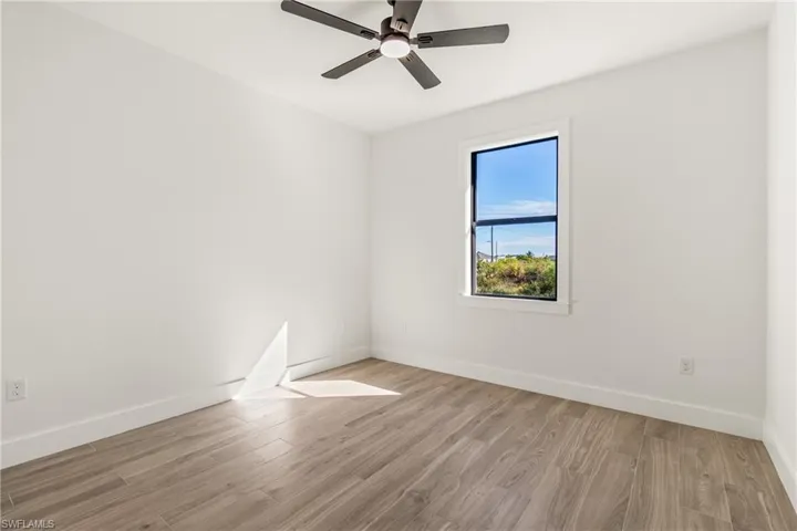 Spare room featuring light wood finished floors and ceiling fan