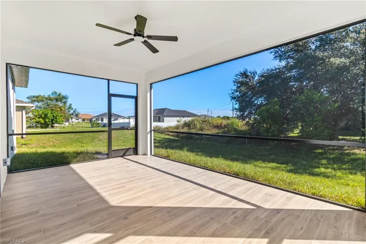 Unfurnished sunroom featuring ceiling fan