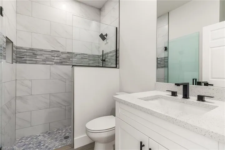 Full bath featuring vanity and walk in shower