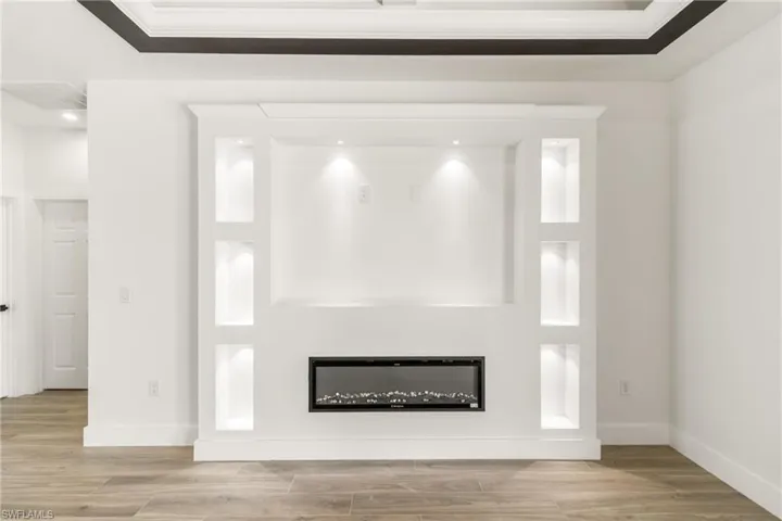 Detailed view of a glass covered fireplace and wood finished floors