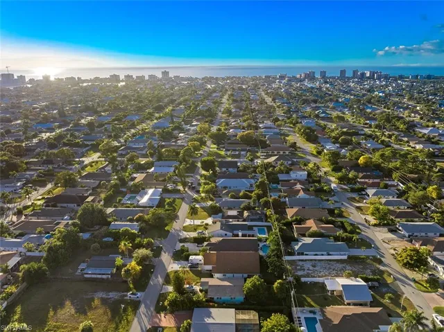 Aerial overview of property's location featuring city skyline and nearby suburban area