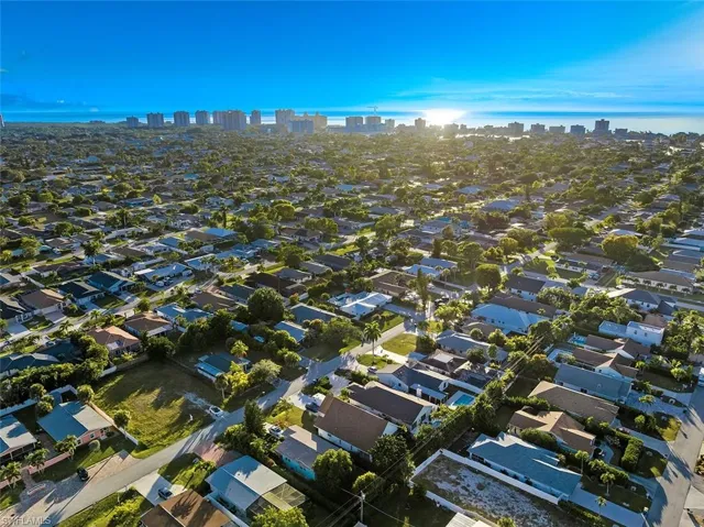 Aerial view of property and surrounding area with city skyline and nearby suburban area