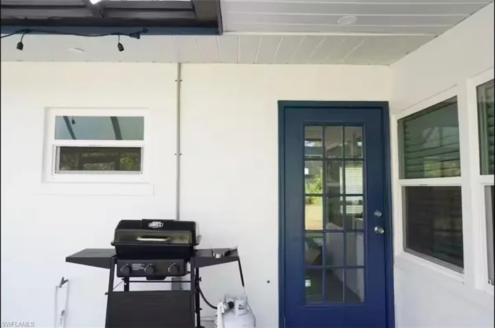 Covered patio area featuring a white plank ceiling and recessed lighting