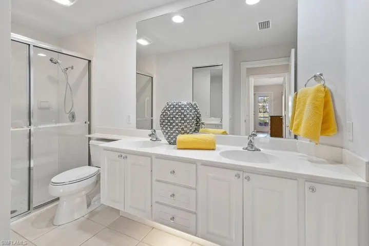 Spacious, neutral master bathroom with large linen closet