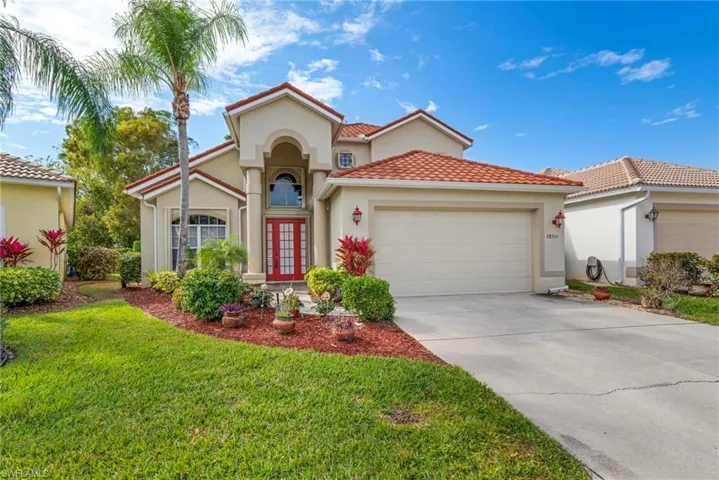 Mediterranean / spanish-style home featuring french doors, a two car garage, stucco siding, new metal roof, a front lawn, and driveway