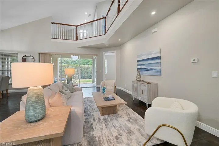 Living room with a high ceiling and recessed lighting