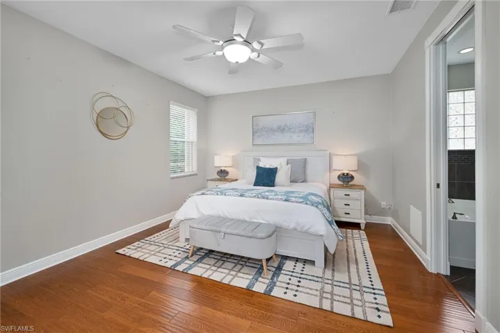 Primary bedroom featuring wood flooring and ceiling fan