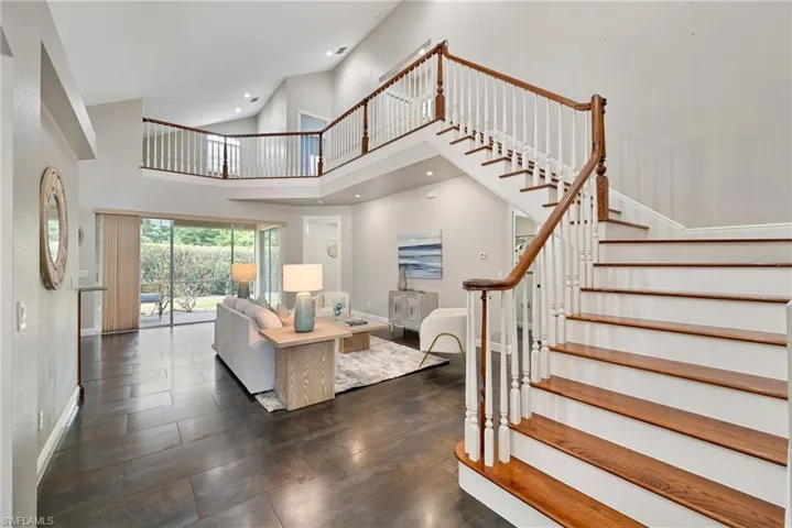 Staircase to second floor with wood floors