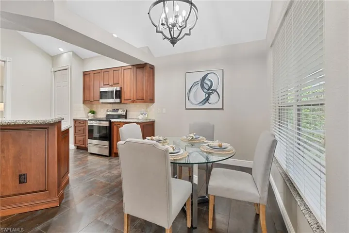 Dining area featuring suspended lighting and lofted ceiling