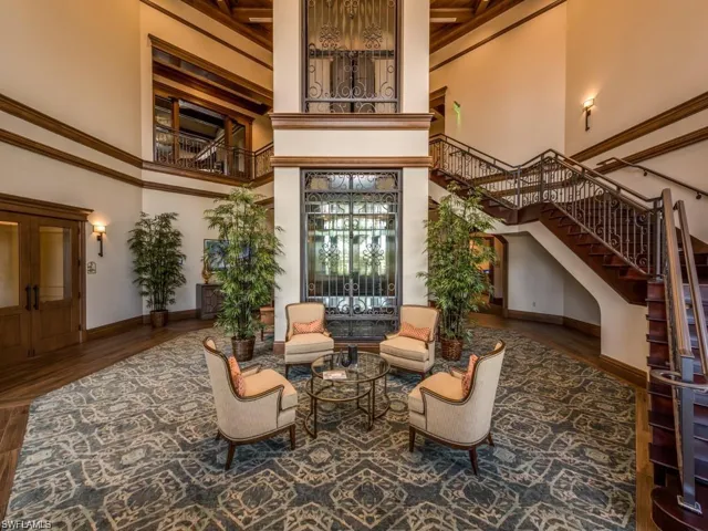 Common area with stairs and a high ceiling