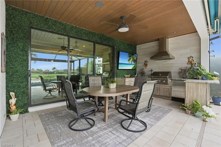 View of patio with an outdoor kitchen / dining area and a ceiling fan