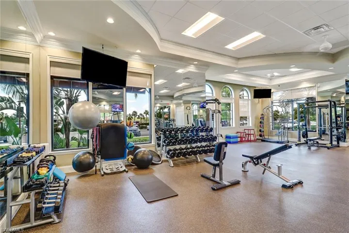 Workout area featuring crown molding