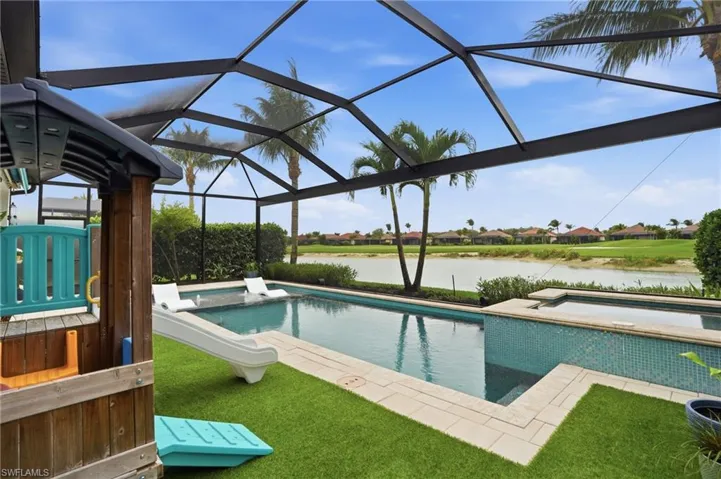 Outdoor pool with an in-ground hot tub, a residential view, a lanai, a water view, and a sunroom