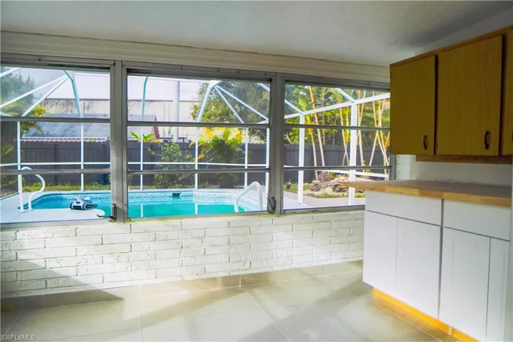 View of pool with a sunroom