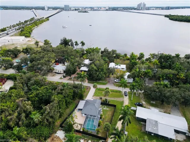 Aerial view of property and surrounding area featuring a large body of water