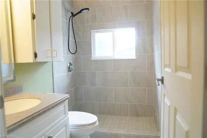 Bathroom with vanity and a stall shower
